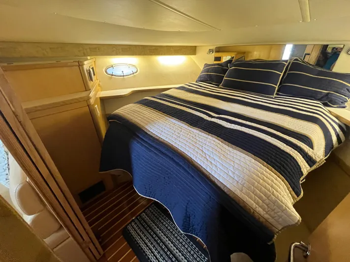  Yacht Photos Pics Cozy cabin interior of 2001 Tiara Yachts 4100 Open with striped bedding.