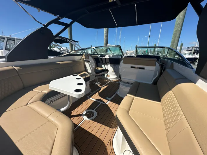  Yacht Photos Pics 2019 Sea Ray SLX 280 boat interior with tan seating and a white table.