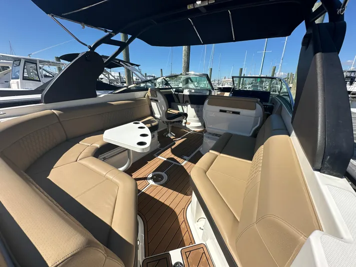  Yacht Photos Pics 2019 Sea Ray SLX 280 boat interior with tan seating and wood flooring.