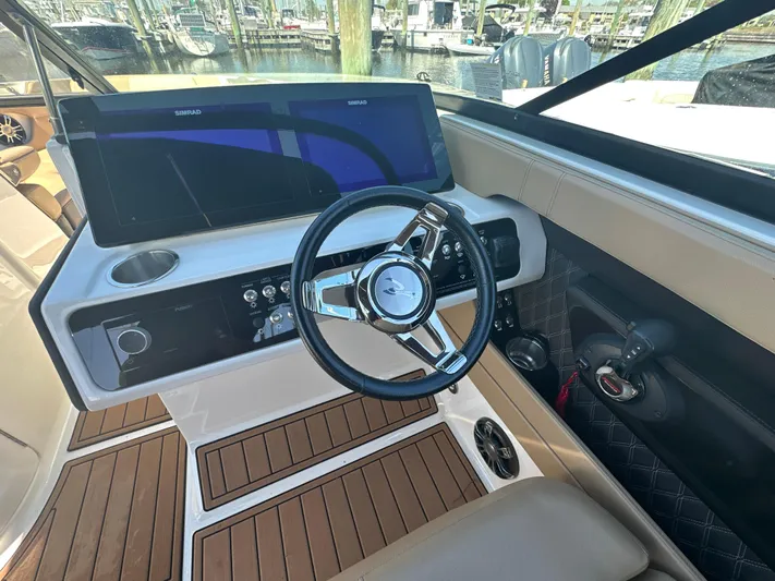  Yacht Photos Pics 2019 Sea Ray SLX 280 helm with modern steering wheel and dashboard controls.