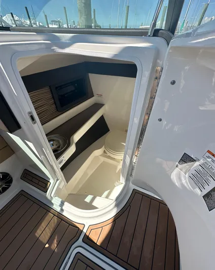  Yacht Photos Pics 2019 Sea Ray SLX 280 boat interior with wood flooring and compact cabin space.