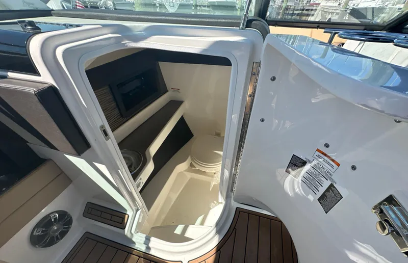  Yacht Photos Pics 2019 Sea Ray SLX 280 boat interior with open cabin door, showcasing compact amenities.