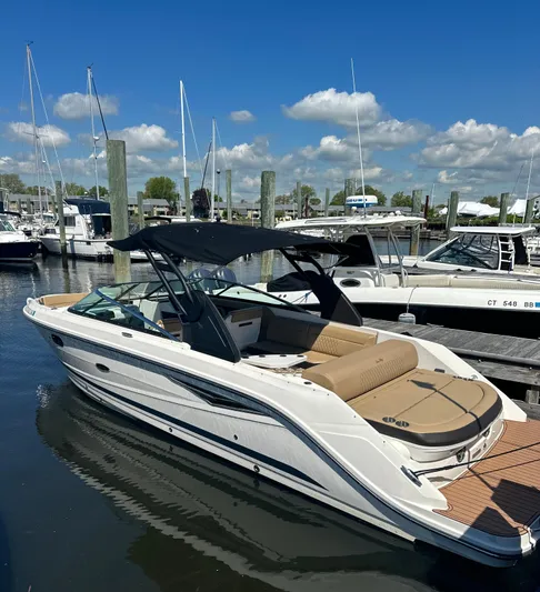  Yacht Photos Pics 2019 Sea Ray SLX 280 boat docked at marina under clear blue sky.