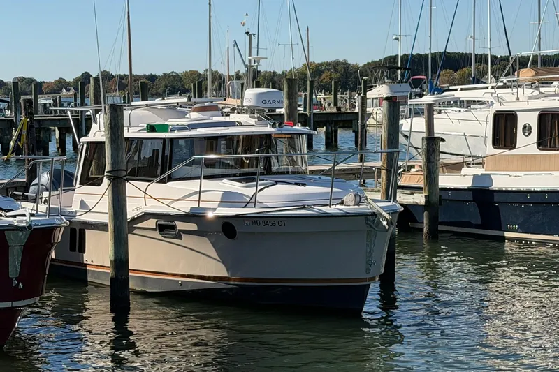 Getting There Yacht Photos Pics 2023 Ranger Tugs R-25 docked at a marina, surrounded by other boats.