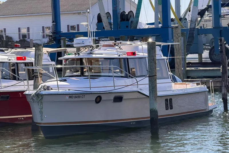 Getting There Yacht Photos Pics 2023 Ranger Tugs R-25 boat docked at a marina, featuring modern design and equipment.