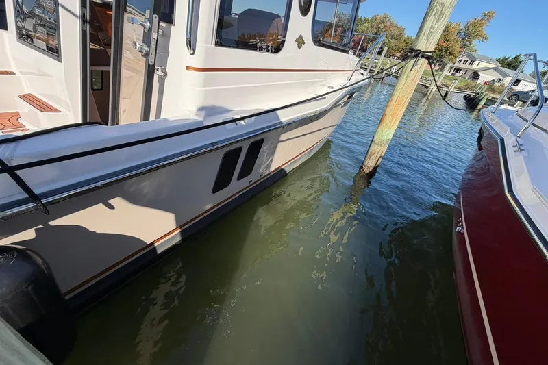 Getting There Yacht Photos Pics 2023 Ranger Tugs R-25 docked, showcasing sleek design and modern features.