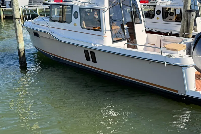 Getting There Yacht Photos Pics 2023 Ranger Tugs R-25 boat docked in marina, side view.