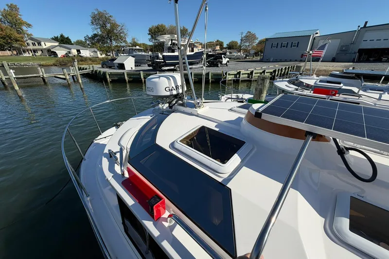 Getting There Yacht Photos Pics 2023 Ranger Tugs R-25 boat docked, featuring solar panels and Garmin equipment.