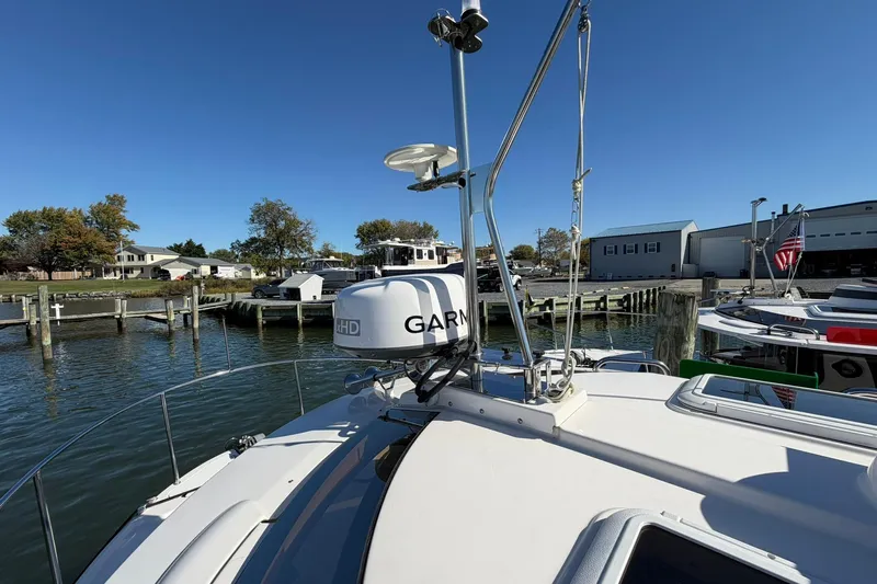 Getting There Yacht Photos Pics 2023 Ranger Tugs R-25 boat docked, featuring Garmin radar, under clear blue sky.