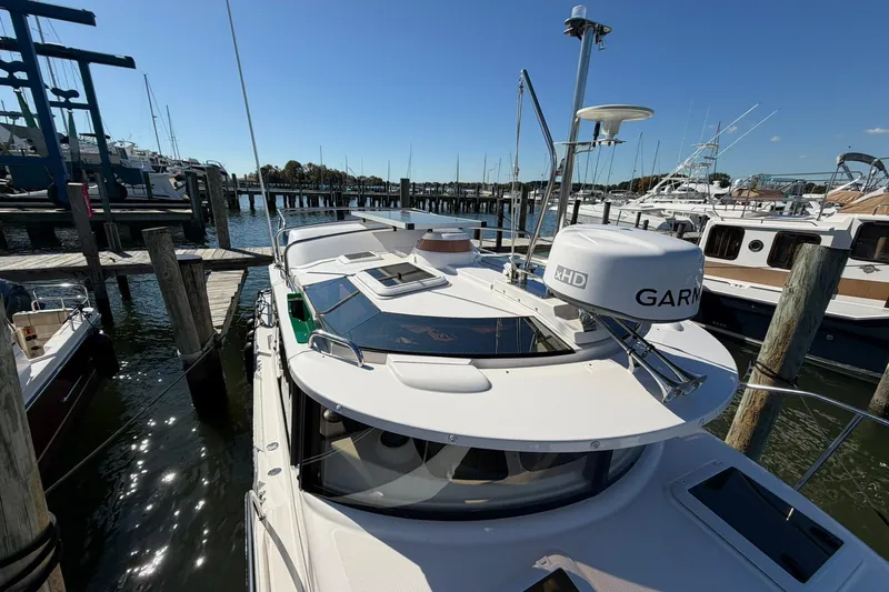 Getting There Yacht Photos Pics 2023 Ranger Tugs R-25 docked at marina, featuring Garmin radar and sleek design.