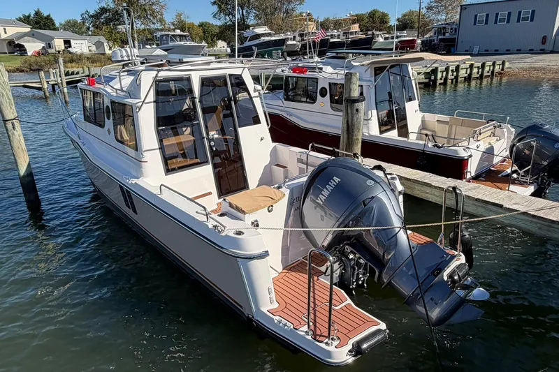 Getting There Yacht Photos Pics 2023 Ranger Tugs R-25 boat docked with Yamaha outboard motor, sunny marina setting.