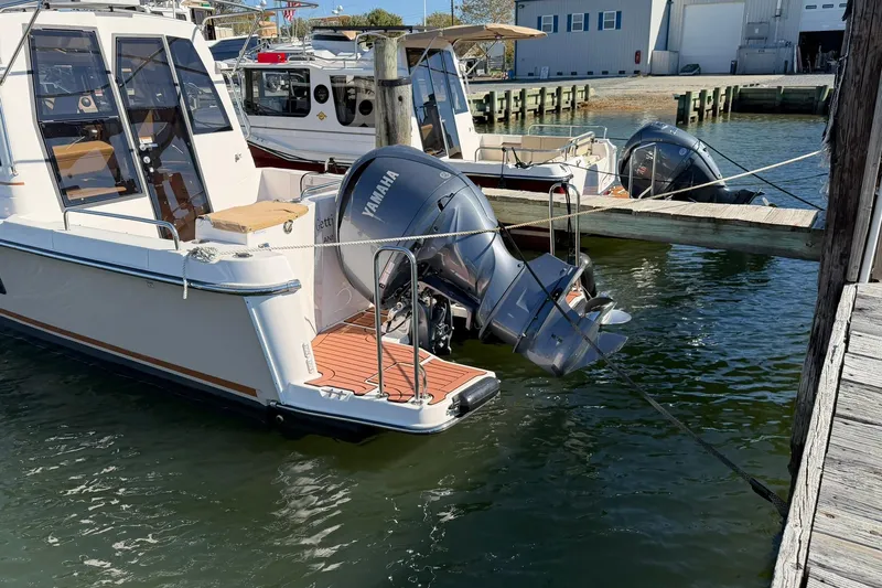Getting There Yacht Photos Pics 2023 Ranger Tugs R-25 boat docked with Yamaha outboard motor.