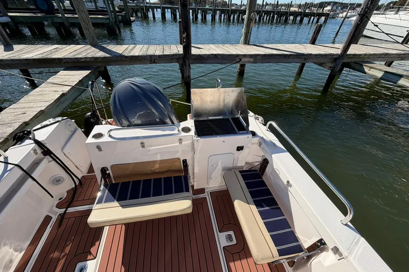 Getting There Yacht Photos Pics 2023 Ranger Tugs R-25 boat deck with seating and grill by the water.