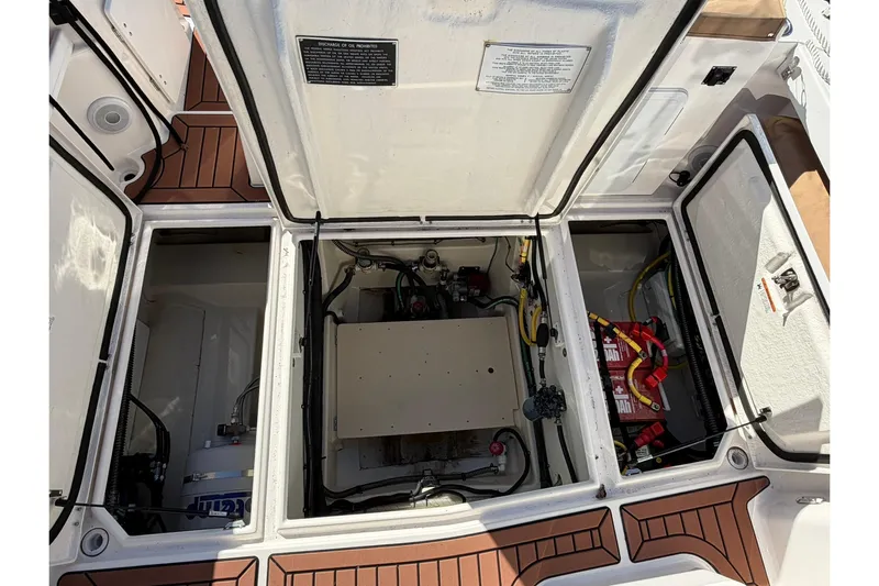 Getting There Yacht Photos Pics 2023 Ranger Tugs R-25 engine compartment with visible wiring and components.