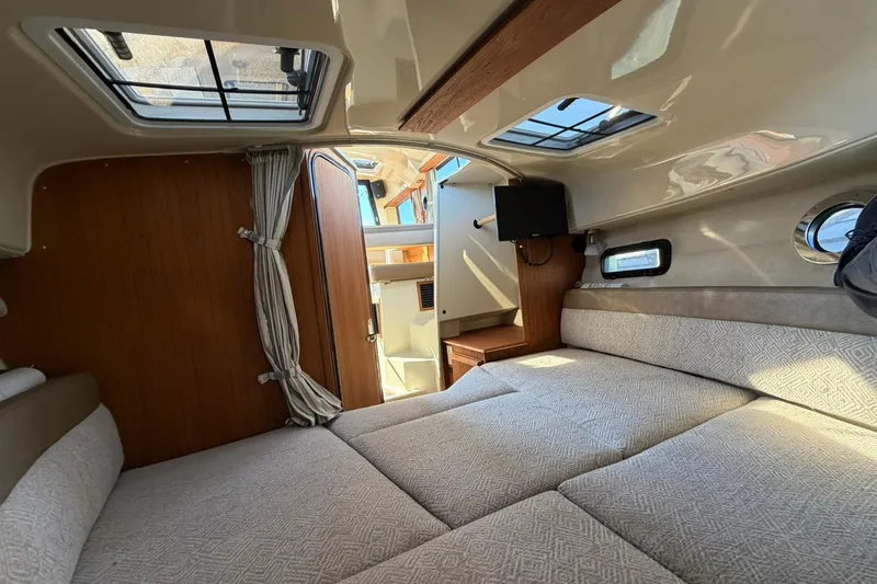 Getting There Yacht Photos Pics 2023 Ranger Tugs R-25 interior cabin with cozy bed and natural light.