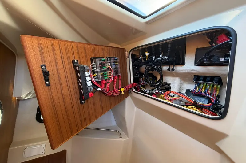 Getting There Yacht Photos Pics Electrical panel inside 2023 Ranger Tugs R-25 boat, showcasing wiring and components.
