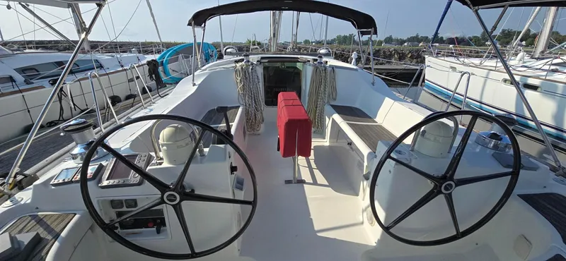Lucy In The Sky Yacht Photos Pics 2001 Beneteau Oceanis 473 sailboat cockpit with dual steering wheels in marina setting.