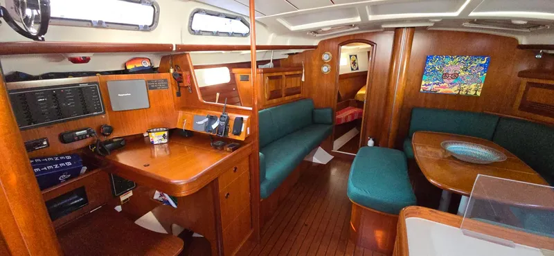 Lucy In The Sky Yacht Photos Pics Interior of 2001 Beneteau Oceanis 473 sailboat with wood finish and seating area.