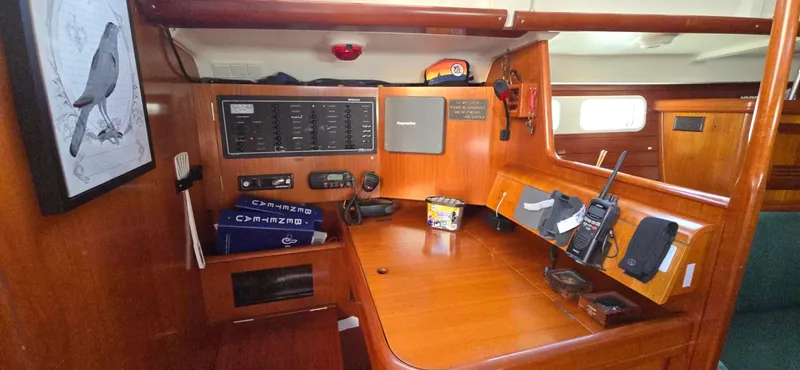 Lucy In The Sky Yacht Photos Pics Navigation station inside 2001 Beneteau Oceanis 473 sailboat, featuring control panels and communication equipment.