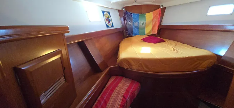 Lucy In The Sky Yacht Photos Pics 2001 Beneteau Oceanis 473 cabin with colorful bedding and wooden interior.