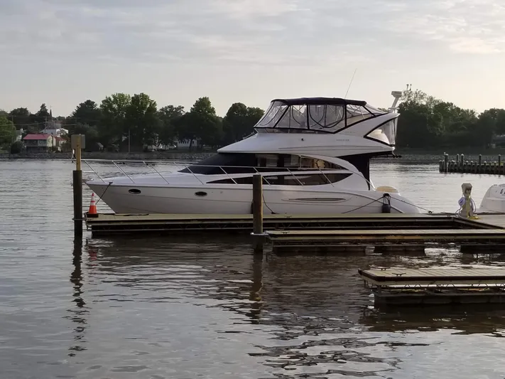  Yacht Photos Pics 2008 Meridian 391 Sedan yacht docked on a calm lake with trees in the background.