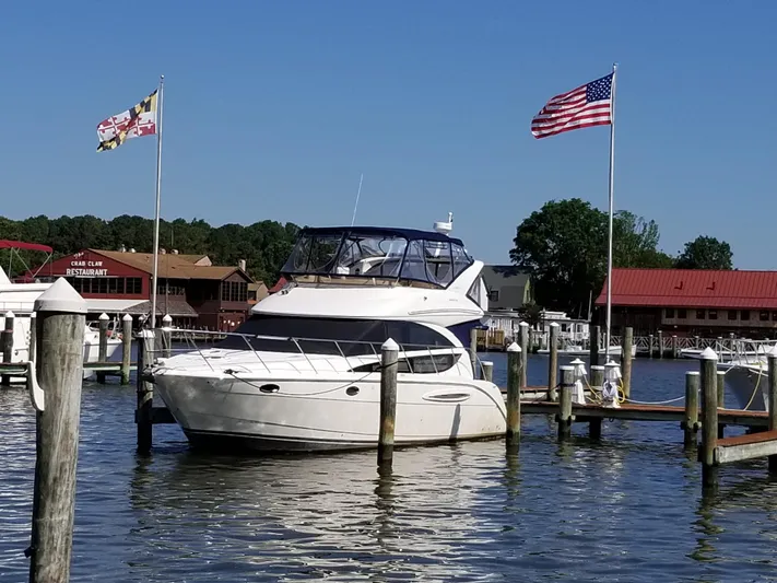  Yacht Photos Pics 2008 Meridian 391 Sedan yacht docked at marina with flags flying.