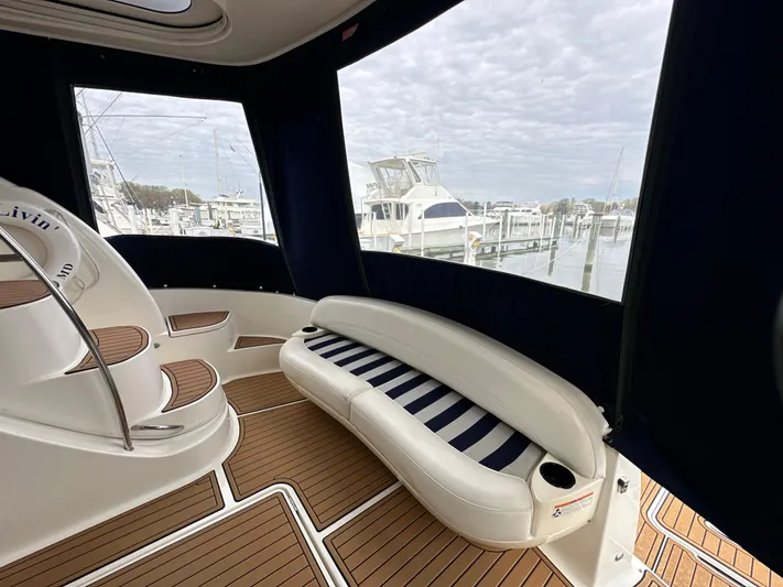  Yacht Photos Pics 2008 Meridian 391 Sedan interior with striped seating and wooden flooring, docked at a marina.