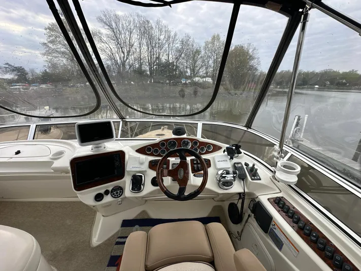  Yacht Photos Pics 2008 Meridian 391 Sedan helm with steering wheel, navigation controls, and panoramic water view.