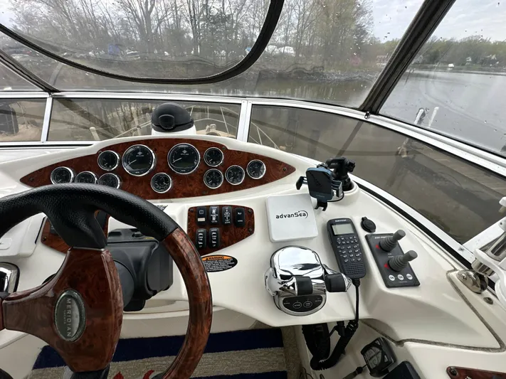  Yacht Photos Pics 2008 Meridian 391 Sedan helm with wood accents, steering wheel, and control panel.