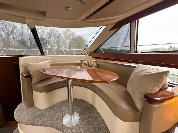  Yacht Photos Pics 2008 Meridian 391 Sedan interior with curved seating and wooden table.