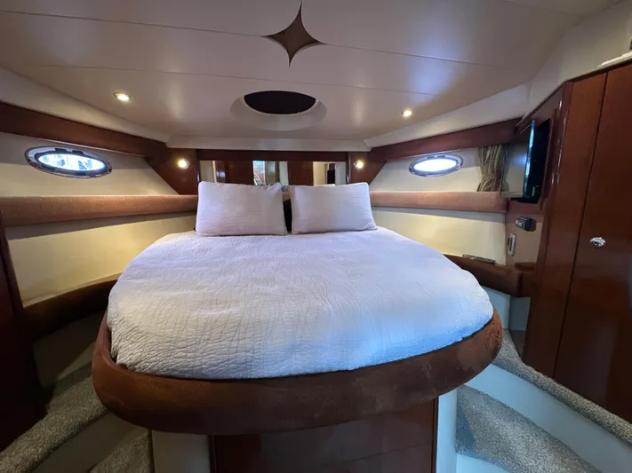  Yacht Photos Pics Luxurious interior of 2008 Meridian 391 Sedan yacht with cozy bed and elegant wood finish.