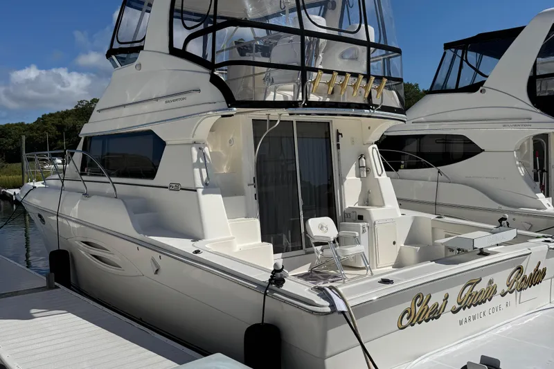 She's From Boston Yacht Photos Pics 2003 Silverton 42 Convertible yacht docked at marina under clear blue sky.