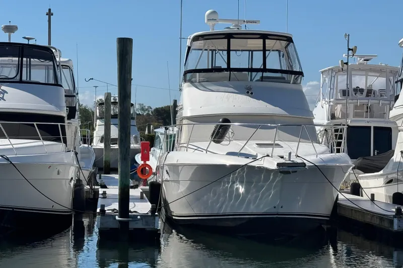She's From Boston Yacht Photos Pics 2003 Silverton 42 Convertible yacht docked at marina, surrounded by other boats.