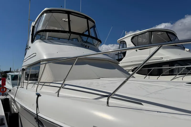 She's From Boston Yacht Photos Pics 2003 Silverton 42 Convertible yacht docked under clear blue sky.
