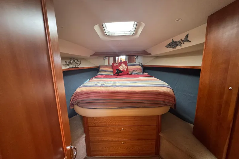 She's From Boston Yacht Photos Pics Cozy bedroom in 2003 Silverton 42 Convertible yacht with striped bedding and nautical decor.