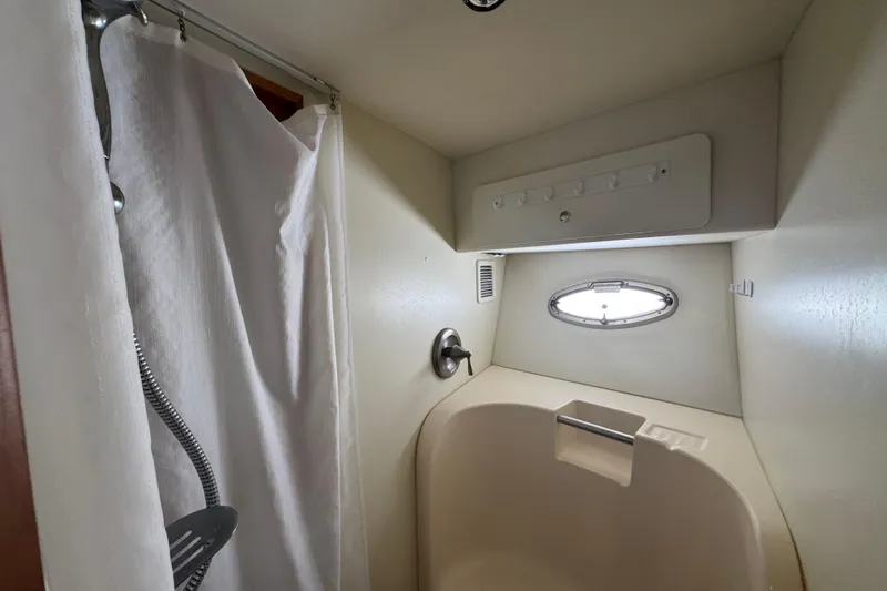 She's From Boston Yacht Photos Pics Shower area in 2003 Silverton 42 Convertible boat with curtain and porthole window.