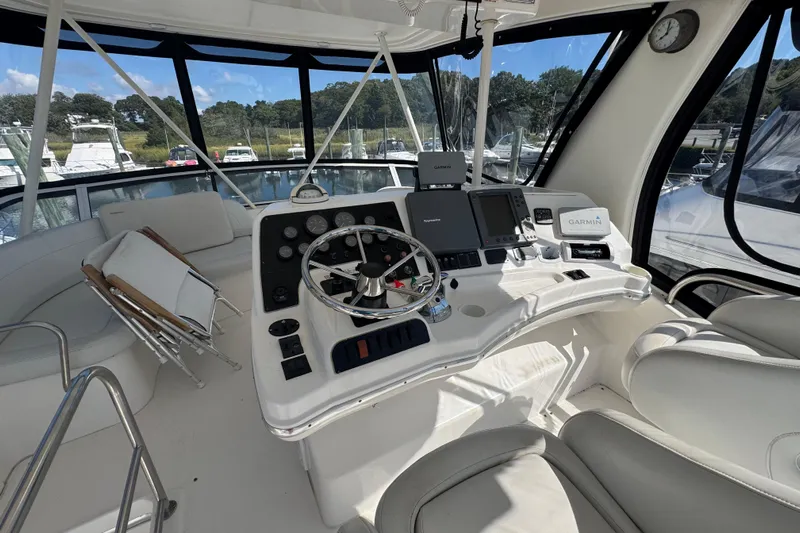 She's From Boston Yacht Photos Pics 2003 Silverton 42 Convertible yacht helm with modern navigation equipment and comfortable seating.