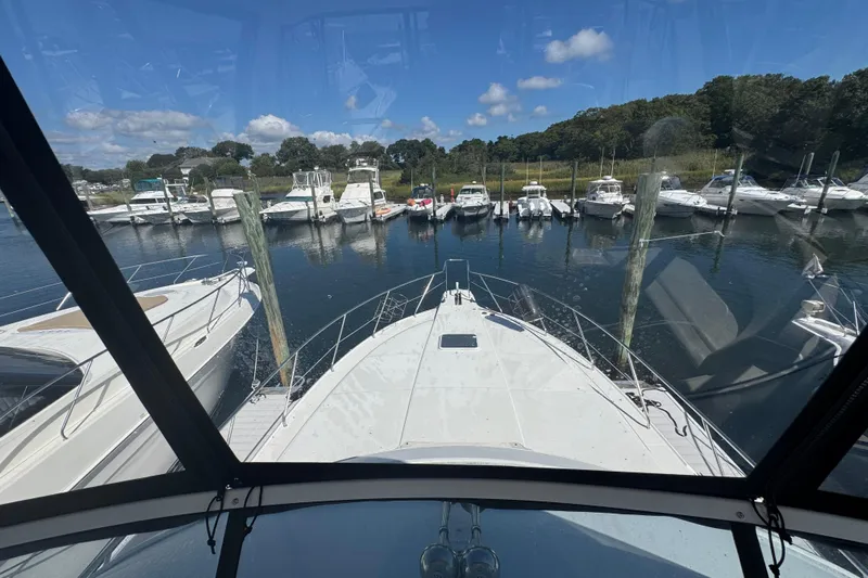 She's From Boston Yacht Photos Pics 2003 Silverton 42 Convertible yacht docked at marina, surrounded by other boats.