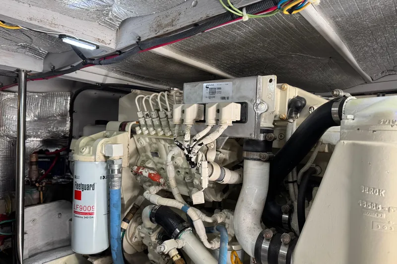 She's From Boston Yacht Photos Pics Engine room of a 2003 Silverton 42 Convertible boat, showcasing mechanical components and wiring.