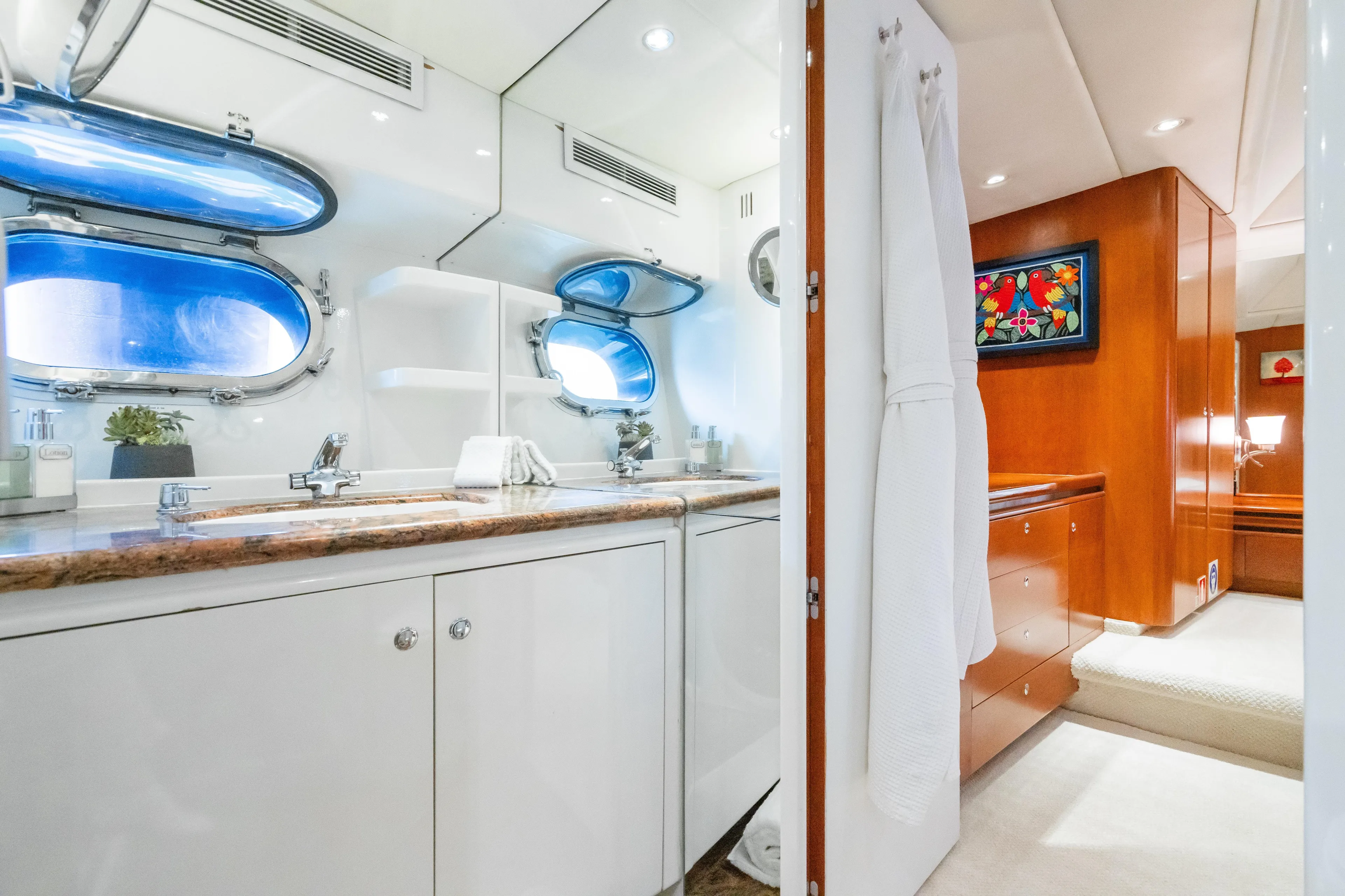 Seaquell Yacht Photos Pics Luxurious bathroom interior of 1992 Alloy Yachts sailboat with double sinks and porthole windows.