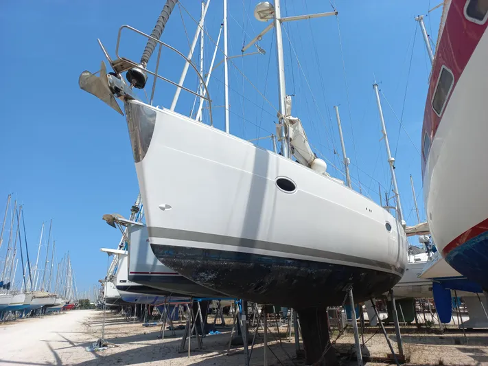  Yacht Photos Pics 2005 Elan Impression 434 sailboat on dry dock, surrounded by other vessels.