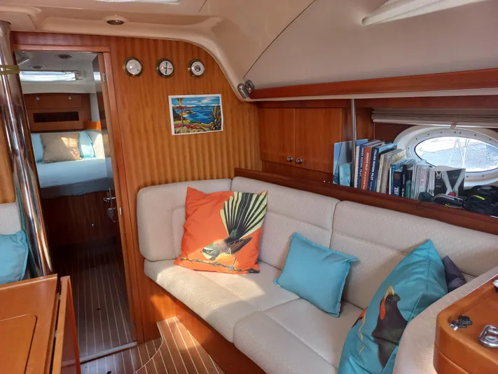  Yacht Photos Pics Interior of 2005 Elan Impression 434 yacht with cozy seating and nautical decor.