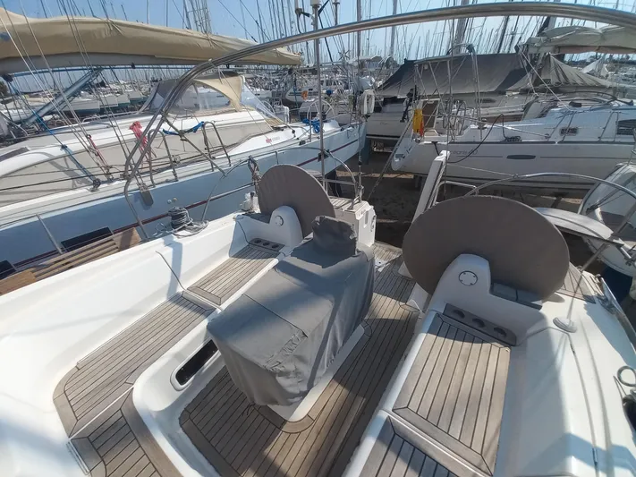  Yacht Photos Pics Elan Impression 434 yacht cockpit, 2005 model, docked in a marina with wooden deck.