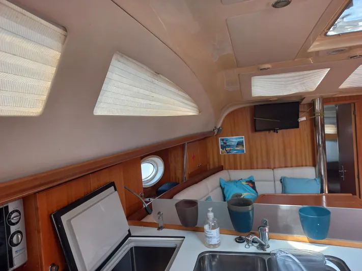  Yacht Photos Pics Interior of 2005 Elan Impression 434 yacht with modern kitchen and cozy seating area.