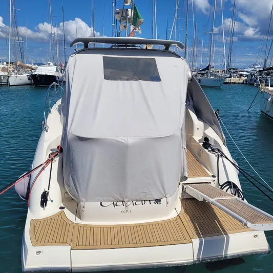  Yacht Photos Pics 2006 Cranchi Mediterranee 47 HT yacht docked in marina, covered deck, clear sky.