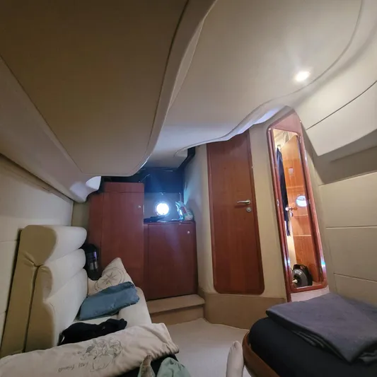  Yacht Photos Pics Interior cabin of 2006 Cranchi Mediterranee 47 HT yacht, featuring cozy seating and wooden cabinetry.