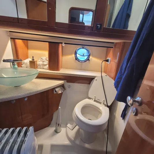  Yacht Photos Pics Luxurious bathroom in 2006 Cranchi Mediterranee 47 HT yacht with modern fixtures and porthole.