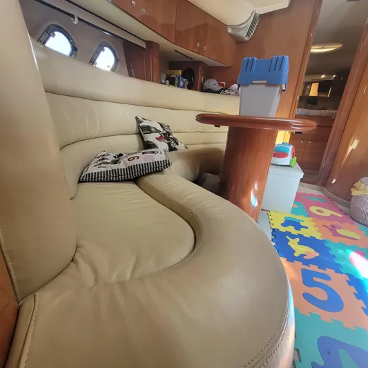  Yacht Photos Pics Interior of 2006 Cranchi Mediterranee 47 HT yacht with beige leather seating and colorful play mat.