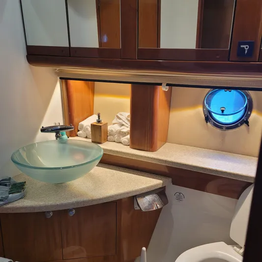  Yacht Photos Pics Luxurious bathroom in 2006 Cranchi Mediterranee 47 HT yacht with glass sink and porthole.