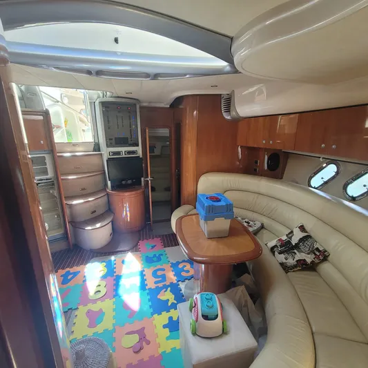  Yacht Photos Pics Luxurious 2006 Cranchi Mediterranee 47 HT yacht interior with plush seating and colorful play area.